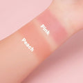 Bella Beauté Creamy Blush swatches on arm in Pink and Peach shades. Creamy, blendable formula for cheeks and lips.