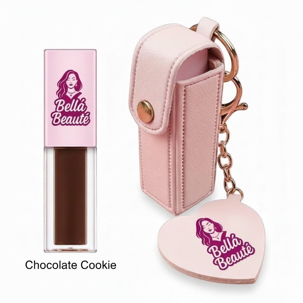 Bella Beauté Chocolate Cookie flavored lip oil in a clear tube with a pink cap, attached to a pink keychain holder with a heart charm.