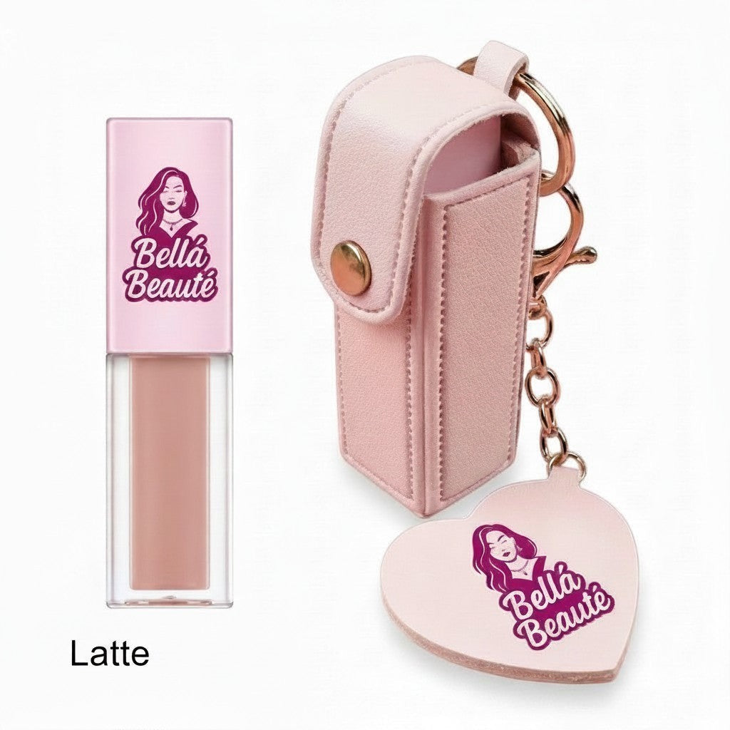 Bella Beauté latte lip oil with a pink faux leather keychain holder and heart-shaped mirror charm.
