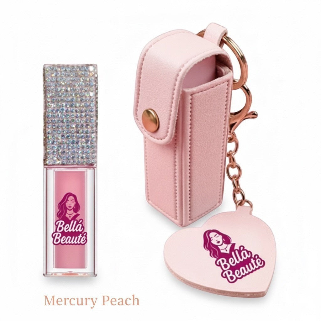 Bella Beauté Magic Color-Changing Lip Oil in Mercury Peach with rhinestone cap and pink keychain holder.