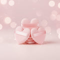 Bella Beauté pink heart-shaped powder puffs with satin ribbon, set of 5, for flawless makeup application.
