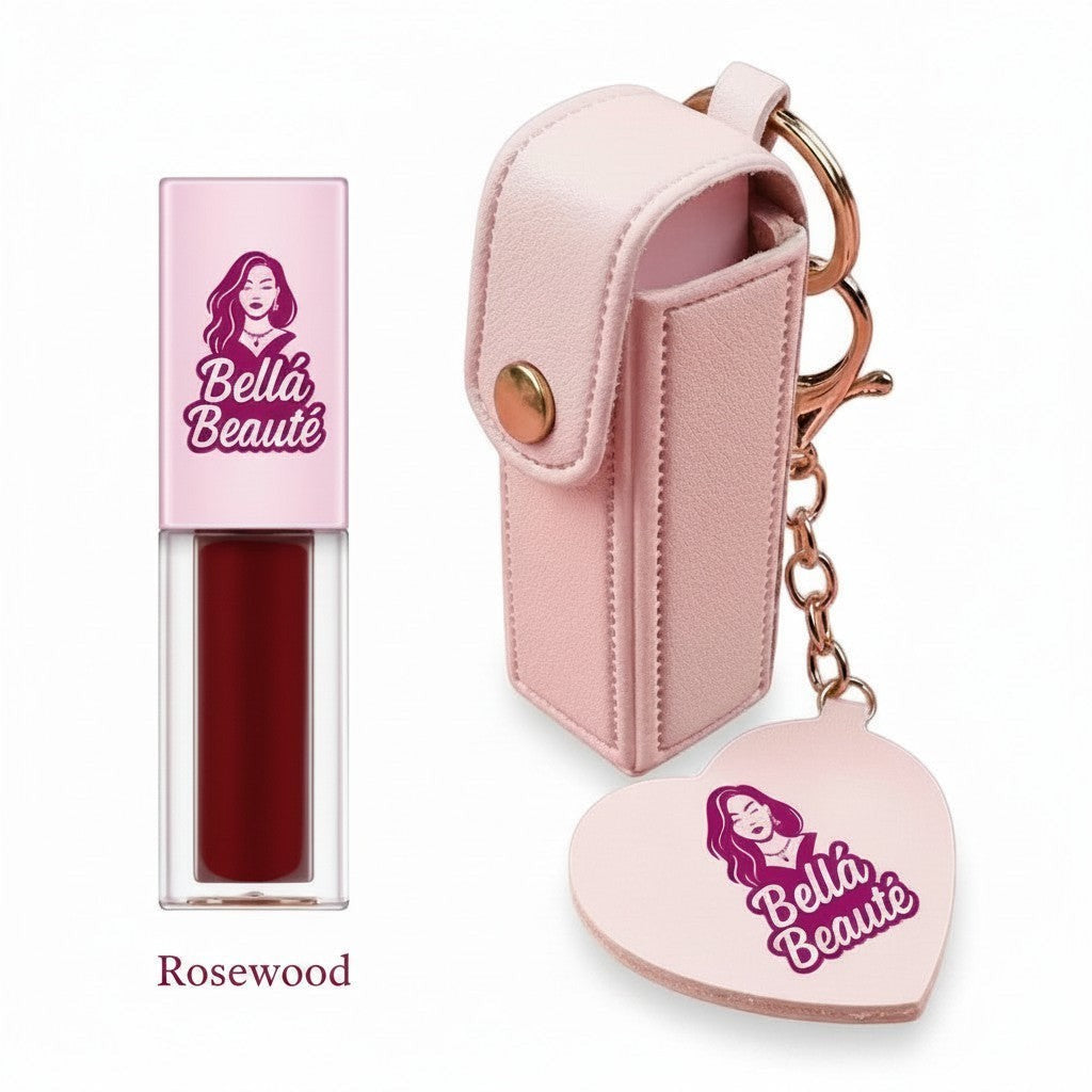 Bella Beauté Rosewood lip oil in a clear tube with a pink cap, attached to a pink keychain holder with a heart charm and mirror.