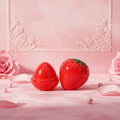 Bella Beauté strawberry-shaped lip balm tint in red, offering deep moisturization and a natural red tint. Vegan-friendly.