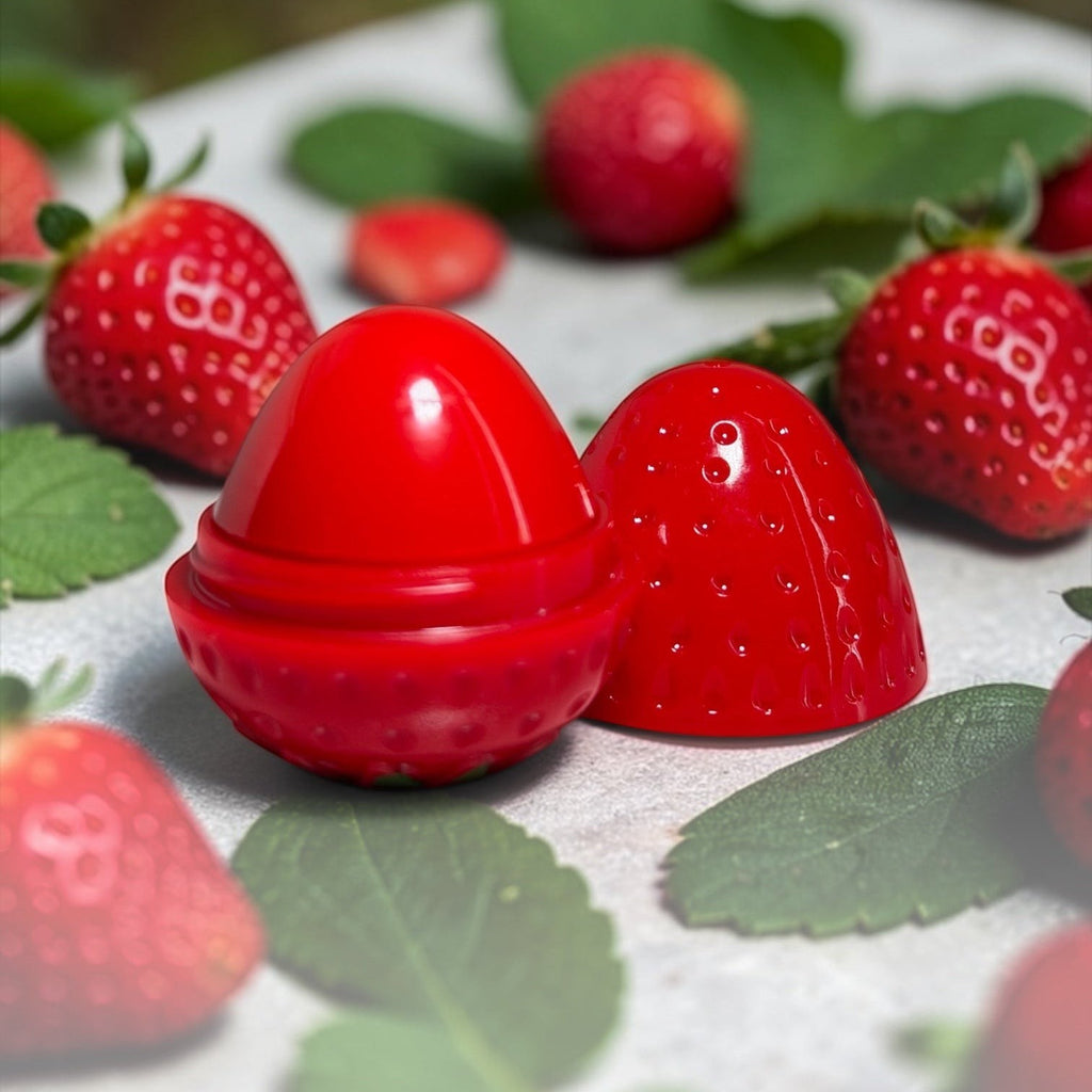 Bella Beauté Strawberry Glow Lip Balm Tint in cute strawberry-shaped packaging, providing natural red tint and deep moisture.