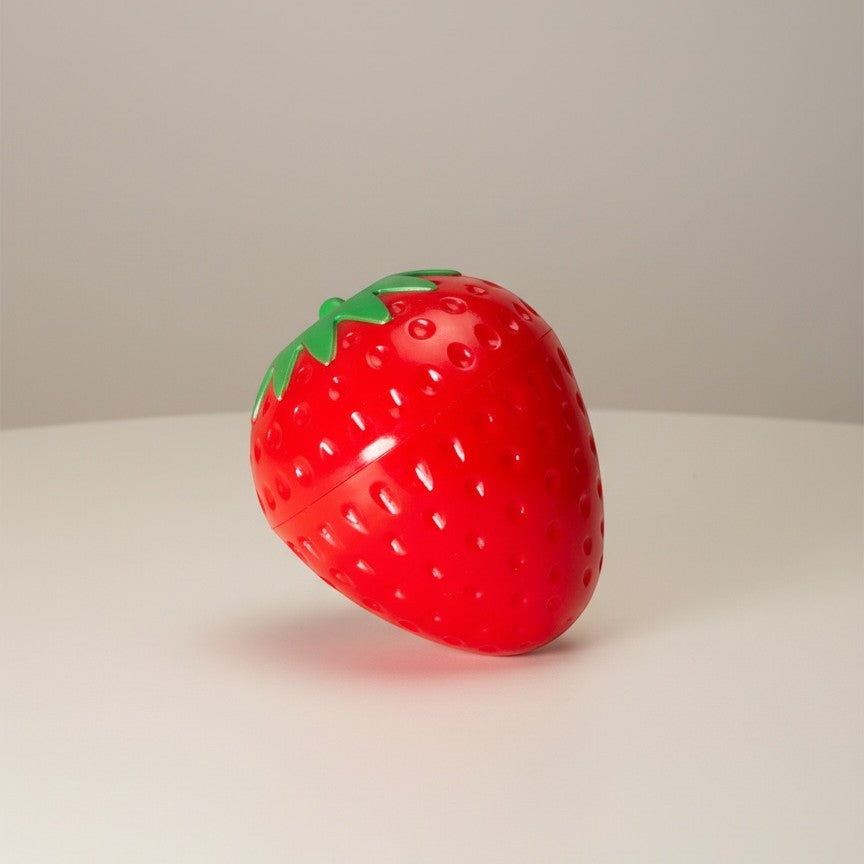 Bella Beauté Strawberry Glow Lip Balm Tint in cute strawberry-shaped packaging, providing natural red tint and deep moisture.
